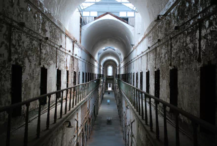 HD desktop wallpaper featuring the architectural interior of an old prison with arches and weathered walls, showcasing man-made structural design.