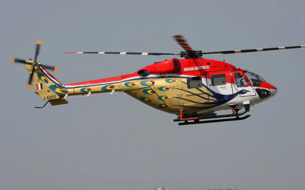 HD wallpaper of a HAL Dhruv military helicopter in flight against a clear sky, showcasing its detailed design and colors.