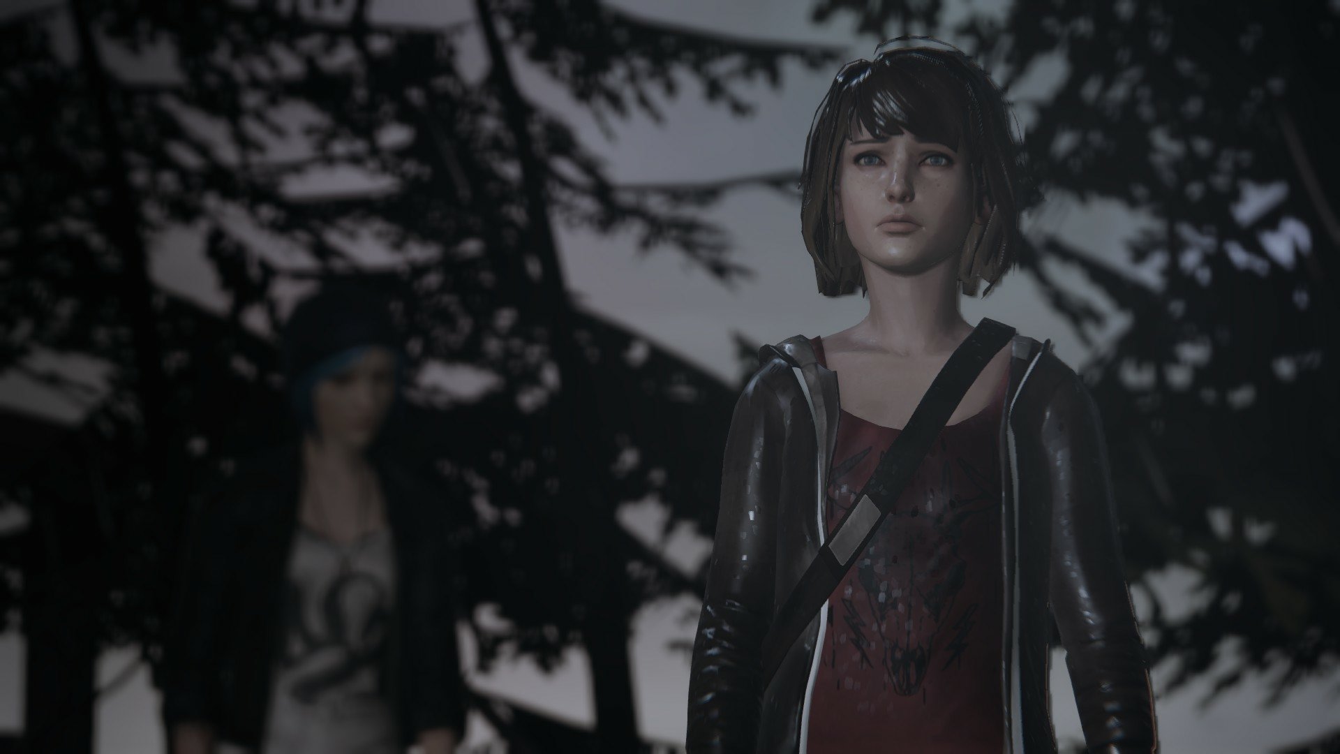 HD PC desktop wallpaper from Life Is Strange: Max Caulfield stands solemnly in the forest foreground with Chloe Price blurred behind, silhouetted pines and moody dusky lighting.