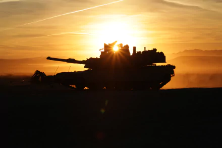 Silhouette of an M1 Abrams tank against a vibrant sunrise with a sunbeam shining through, captured in stunning 4K Ultra HD as a military-themed desktop wallpaper.