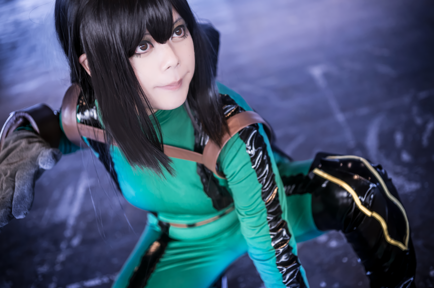 A vibrant HD wallpaper featuring a woman in cosplay as Tsuyu Asui from My Hero Academia, showcasing her character's distinctive green outfit and poised stance.