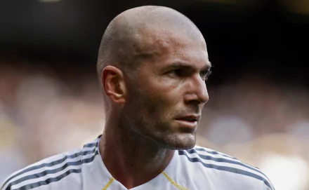 Close-up HD wallpaper of French soccer legend Zinedine Zidane in a white jersey, highlighting his focused expression during a match.