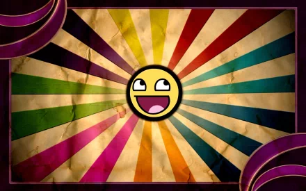 A colorful HD desktop wallpaper featuring a large, smiling emoji at the center, surrounded by vibrant rays of purple, green, yellow, and blue, creating a fun and cheerful atmosphere.