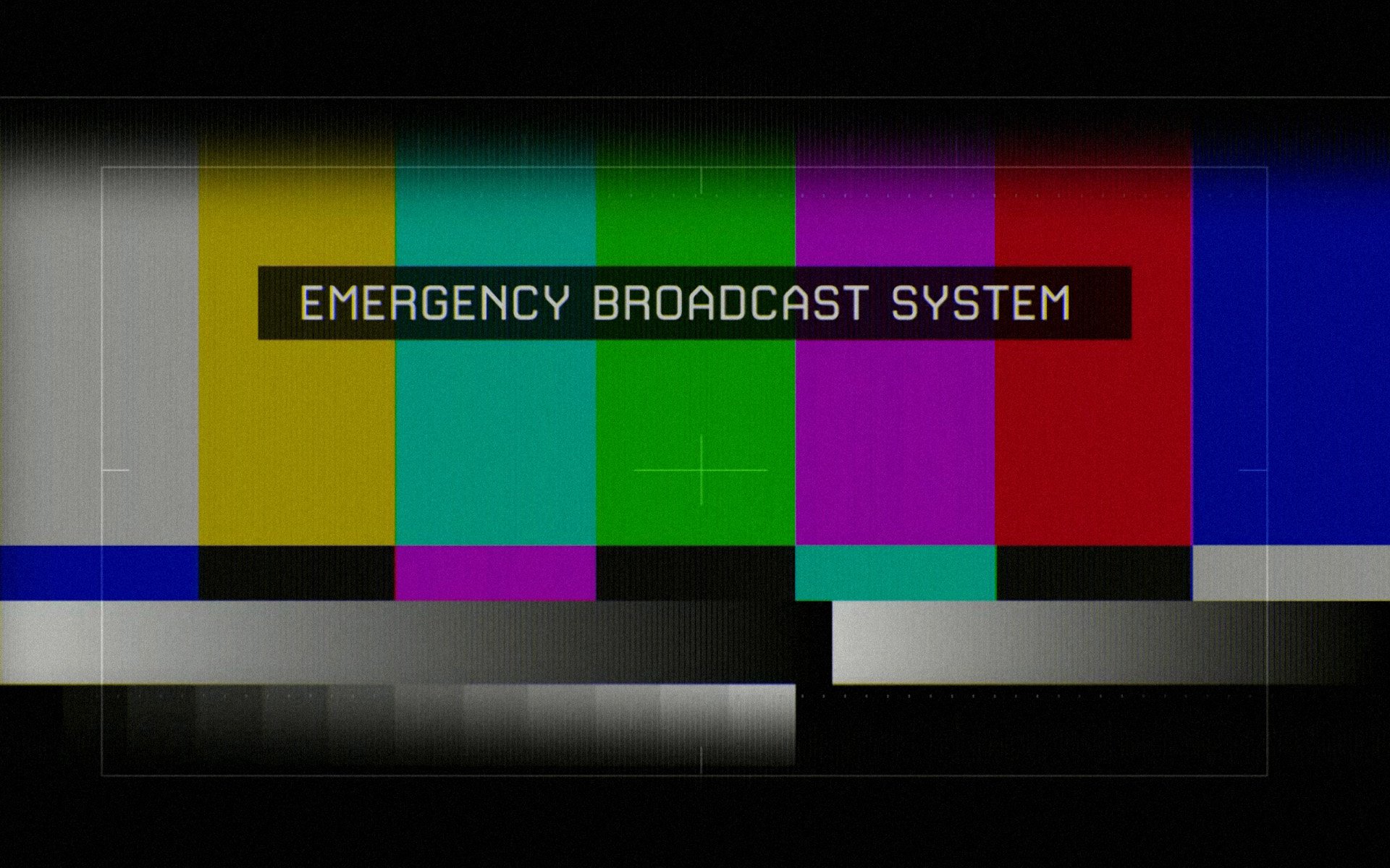 A humorous HD desktop wallpaper featuring colorful static bars and the text EMERGENCY BROADCAST SYSTEM, adding a playful twist to digital backgrounds.