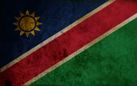 HD PC desktop wallpaper showing the Namibian flag: diagonal red stripe edged in white, blue upper-left with golden sun, green lower-right, textured grunge.