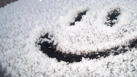 A snowy surface with a smiley face carved into the snow, creating a funny and cheerful HD desktop wallpaper and background.