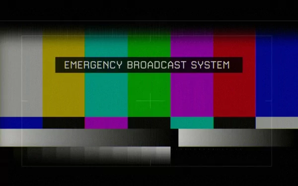 A humorous HD desktop wallpaper featuring colorful static bars and the text EMERGENCY BROADCAST SYSTEM, adding a playful twist to digital backgrounds.