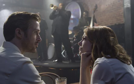 Ryan Gosling and Emma Stone share an intimate moment in a scene from *La La Land*, set against a live jazz backdrop, capturing the film's enchanting atmosphere.