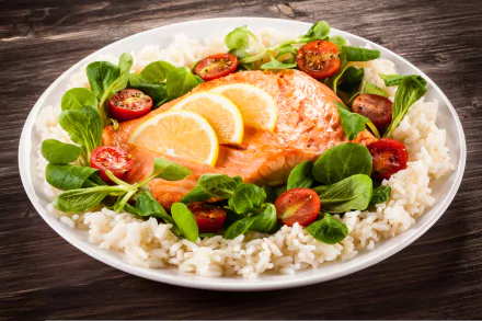 A vibrant 4K Ultra HD desktop wallpaper featuring a meal with cooked salmon garnished with lemon slices, surrounded by rice, fresh salad greens, and halved cherry tomatoes.