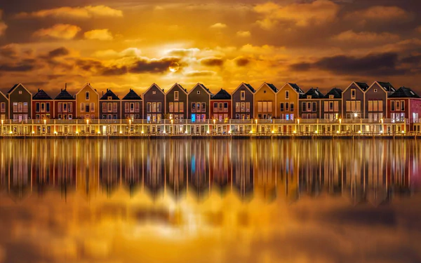 Colorful row of houses in Houten, Netherlands at sunset, reflected in calm water — vibrant man-made town skyline in this HD PC desktop wallpaper and background.