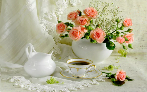 A still life HD desktop wallpaper featuring pink roses arranged in a white pitcher vase, accompanied by a matching saucer and cup on a lace-covered surface.