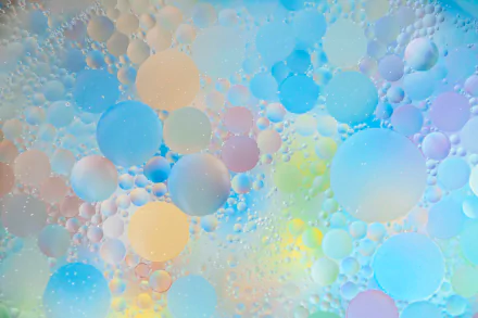 Abstract HD PC wallpaper featuring colorful water droplets forming overlapping circles and dots in soft pastel hues.