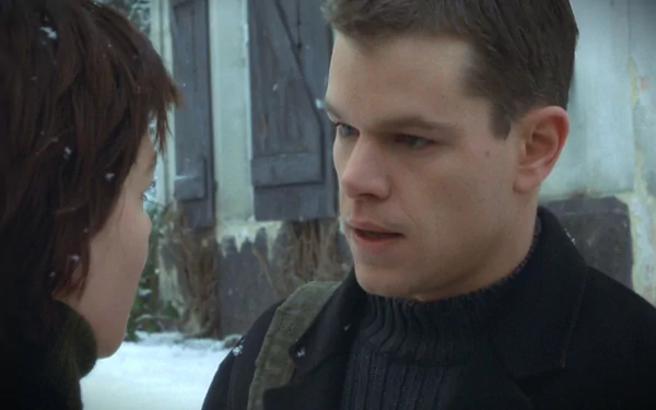 HD PC desktop wallpaper background from the movie The Bourne Identity: snowy close-up of two characters confronting each other, a man in a dark sweater staring intently.