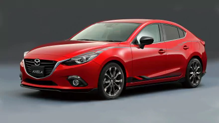 Red Mazda 3 compact car on a neutral background, glossy hatchback profile — 2K Quad HD PC desktop wallpaper of a Mazda vehicle.