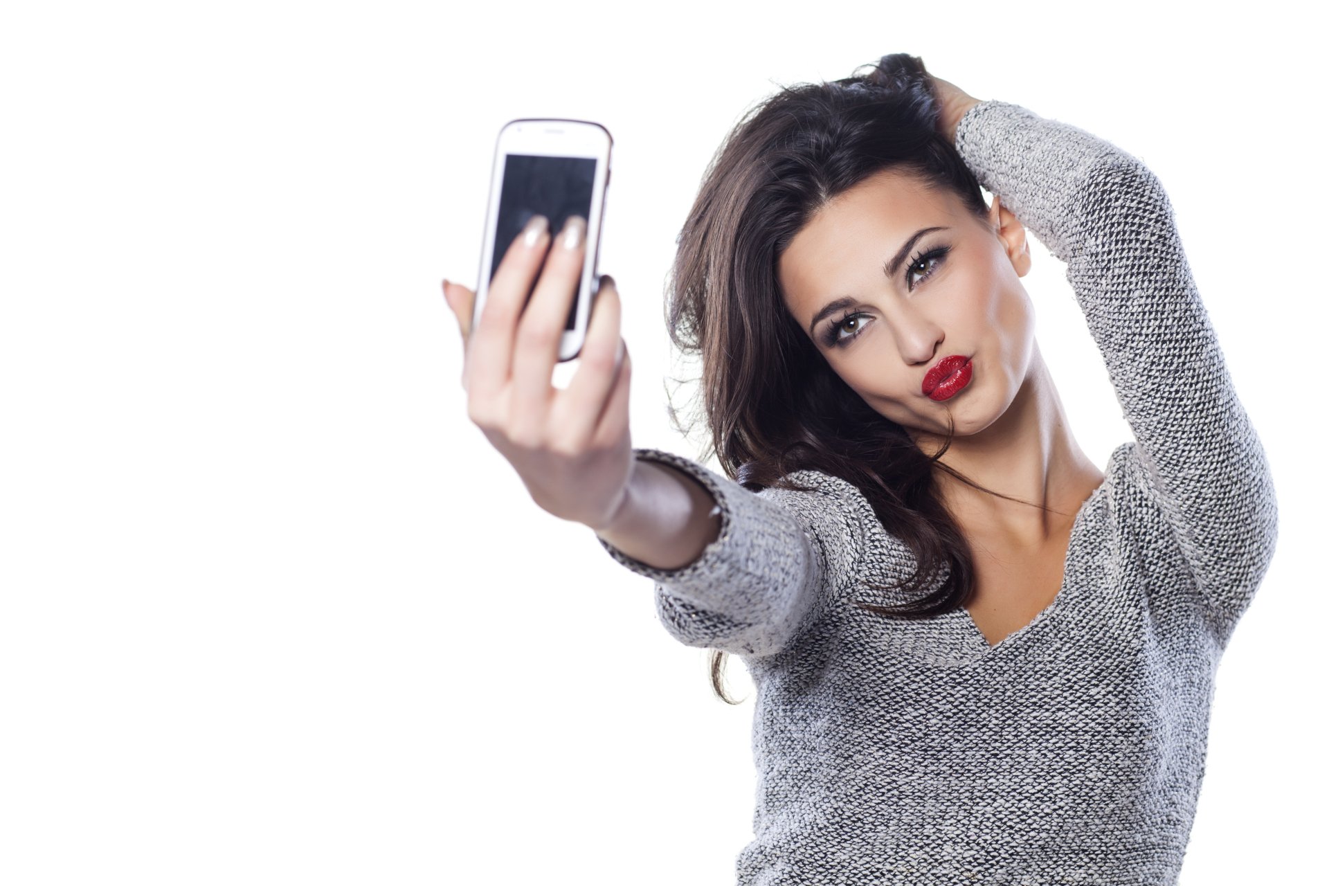 Brunette woman with hazel eyes and red lipstick takes a selfie, captured in sharp 4K Ultra HD detail for a striking PC desktop wallpaper.