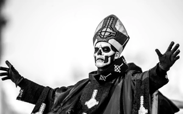 HD desktop wallpaper featuring Ghost B.C., a heavy metal band, with a member dressed in an intricate costume and skull makeup, arms outstretched. The monochrome image captures the dramatic essence of their performance.