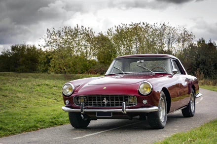 A classic Ferrari 250 GT grand tourer in deep red parked on a countryside road, captured in HD for a striking PC desktop wallpaper background.