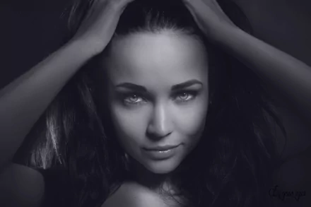 Black and white HD desktop wallpaper featuring a close-up of model Angelina Petrova smiling with her hands in her hair.