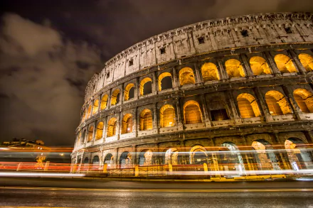 Nighttime light trails and a time-lapse capture of the illuminated Colosseum in Rome, Italy, showcased as an HD PC desktop wallpaper background.