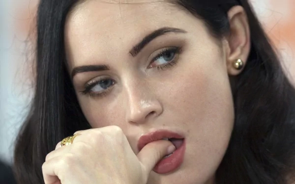 A stunning HD desktop wallpaper featuring celebrity Megan Fox, showcasing her captivating expression and elegant style.