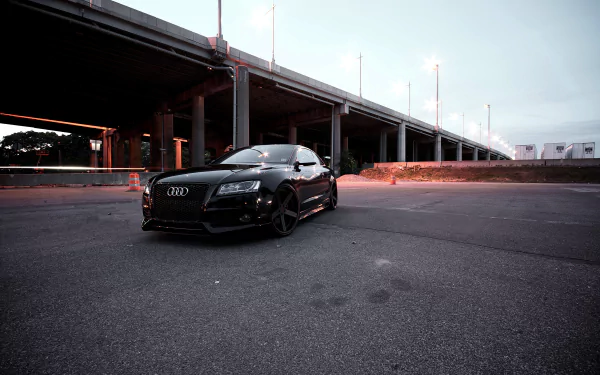 Black Audi RS5 car parked under an overpass at dusk, dramatic low-angle shot — 4K Ultra HD PC desktop wallpaper and background.