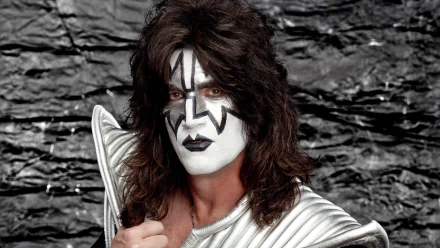 HD desktop wallpaper featuring a member of KISS in signature glam metal and heavy metal attire, complete with black and white face paint against a dark, textured background.
