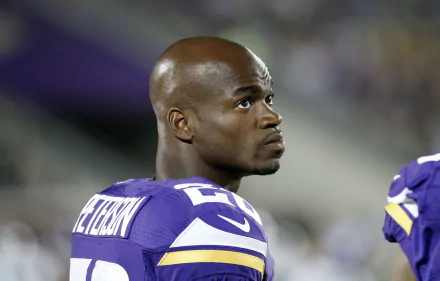 HD wallpaper of a person in a Minnesota Vikings jersey on the field, suited for a football fan's desktop background.