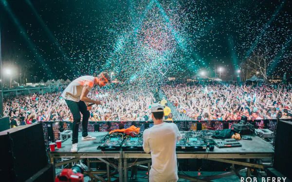 HD desktop wallpaper featuring The Chainsmokers performing live with an energetic crowd and vibrant confetti.