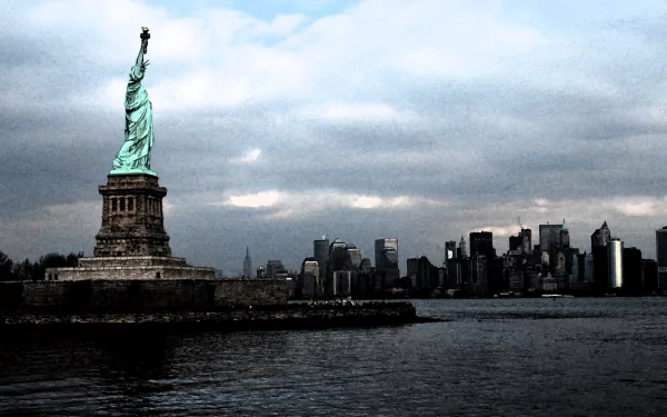 HD desktop wallpaper featuring the man-made Statue of Liberty standing against a cloudy sky with the New York City skyline in the background.