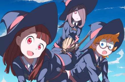 HD anime desktop wallpaper featuring Lotte Yanson, Sucy Manbavaran, and Atsuko Kagari from Little Witch Academia against a bright blue sky background.