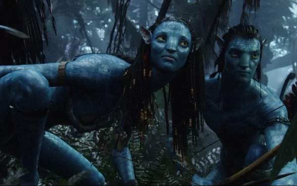 HD desktop wallpaper featuring Jake Sully and Neytiri from the movie Avatar, both with blue skin, brown hair, and yellow eyes, crouching in a lush, forested nature setting and holding weapons.