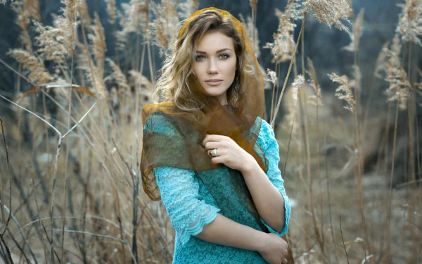 A blonde woman wearing a veil poses in front of plants in an HD desktop wallpaper and background image.
