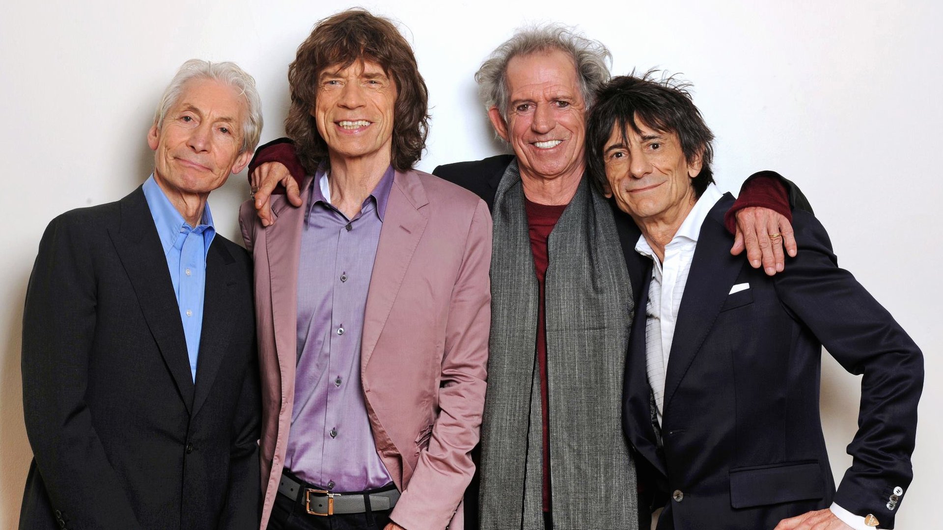 HD desktop wallpaper featuring the iconic rock band The Rolling Stones posing together against a white background.