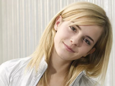 HD desktop wallpaper of celebrity Emma Watson, featuring her smiling softly with a light background.
