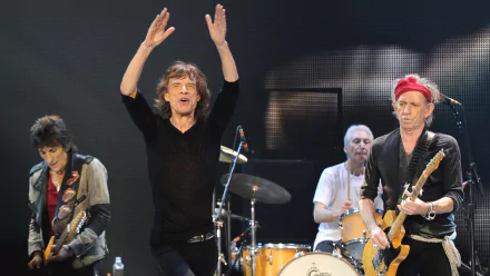 HD desktop wallpaper featuring The Rolling Stones performing live on stage, capturing the energy of the iconic rock band during a music concert.