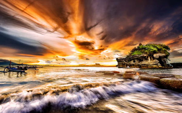 A vibrant HD desktop wallpaper capturing a canoe near a small island with foamy ocean waves under a dramatic sunset sky filled with clouds.