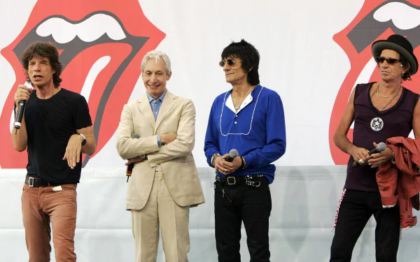 HD desktop wallpaper featuring The Rolling Stones band members standing in front of the iconic red tongue logo, representing classic rock music.