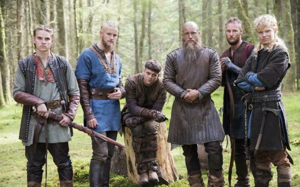 HD desktop wallpaper featuring the main cast of the TV show Vikings (2013) standing in a forest, dressed in period-appropriate Viking attire.