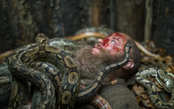 Close-up of a bloodied Viking from the TV show Vikings (2013) entwined by a large snake, captured in 8K Ultra HD wallpaper quality.
