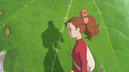 Anime HD PC desktop wallpaper from The Secret World of Arrietty: Arrietty in profile walking on a giant green leaf, her shadow cast behind her.