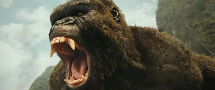 A high-definition desktop wallpaper featuring a roaring Kong from the movie Kong: Skull Island, set against a natural, rugged backdrop.