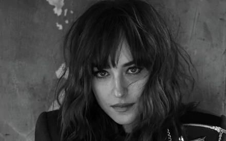 Black and white HD portrait of American actress and celebrity Dakota Johnson, captured with dramatic lighting and textured background, designed as a PC desktop wallpaper.