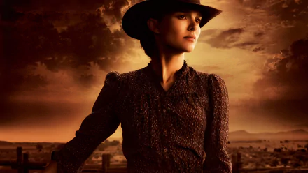 HD desktop wallpaper of Natalie Portman as a determined character in the movie Jane Got a Gun, set against a dramatic, cloudy western sky background.