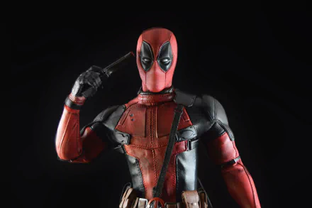 4K Ultra HD desktop wallpaper featuring a detailed Deadpool figurine posed with a gun to his head against a black background.