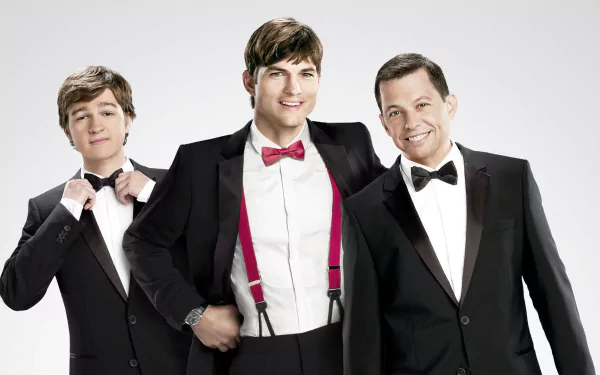 HD desktop wallpaper featuring the main cast of the TV show Two and a Half Men dressed in tuxedos against a white background.
