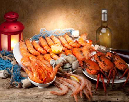 4K Ultra HD PC desktop wallpaper and background: lantern-lit seafood spread of shrimp, prawns, clams, crab and lobster on a rustic table with lemon and a bottle of white wine.