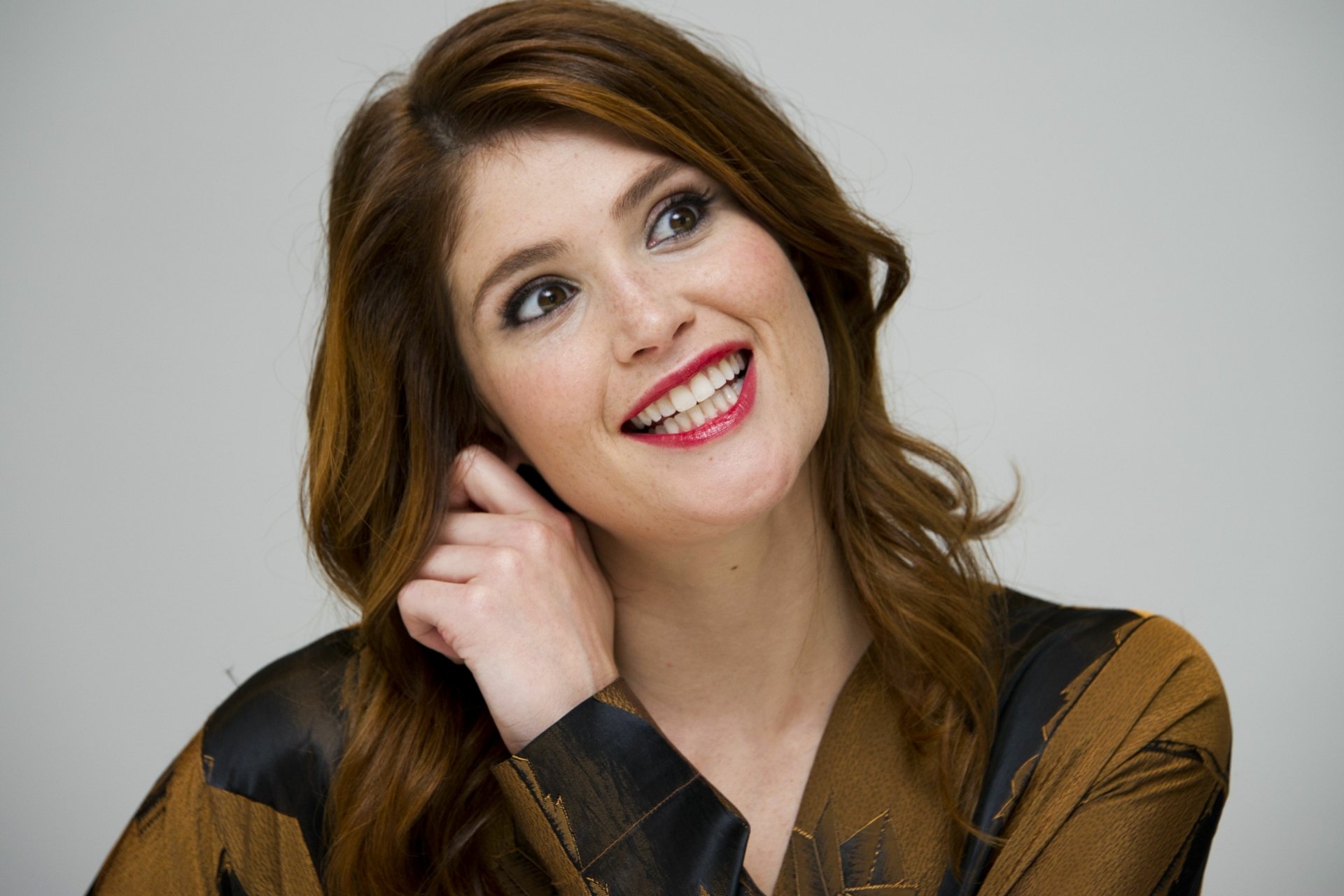 HD desktop wallpaper featuring a close-up of actress and celebrity Gemma Arterton smiling with a light background.