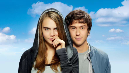 HD desktop wallpaper featuring Cara Delevingne and Nat Wolff from the movie Paper Towns against a bright blue sky with clouds.