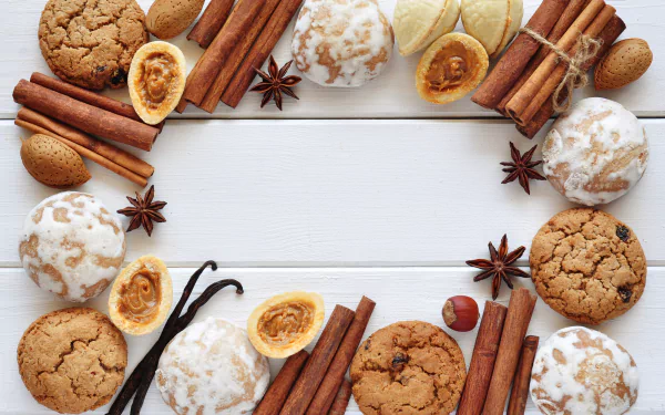 5K Ultra HD PC desktop wallpaper and background: still-life border of cinnamon sticks, star anise, vanilla pods, whole nuts and glazed spiced cookies around a white wooden center.