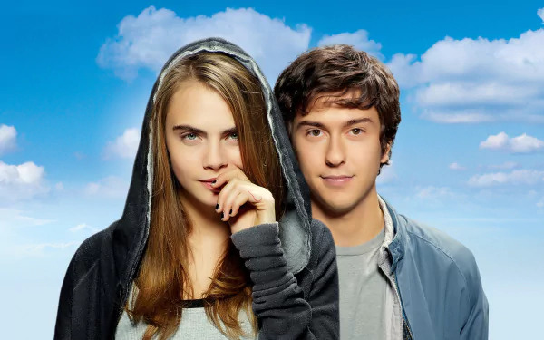 HD desktop wallpaper featuring Cara Delevingne and Nat Wolff from the movie Paper Towns against a bright blue sky with clouds.